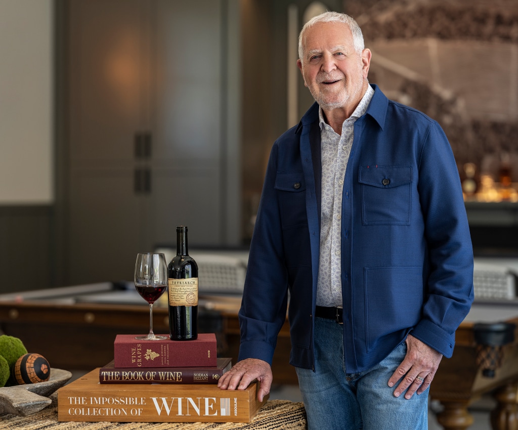 Rich Frank with a bottle of Patriarch Wine and books.