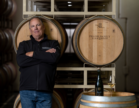 Winemaker, Todd Graff leaning on Chardonnay barrels