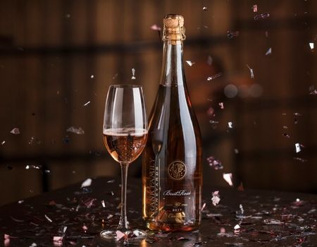 A bottle of Frank Family's Brut Rosé surrounded by confetti 