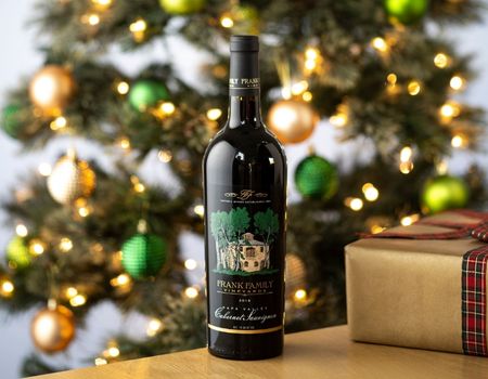 A bottle of Frank Family's Napa Valley Cabernet Set against a Christmas tree