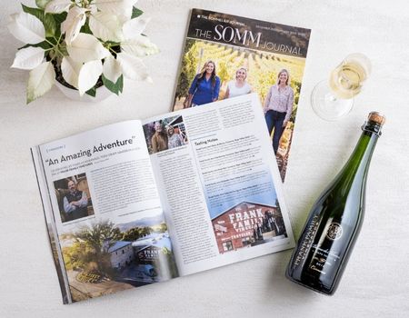Somm Journal Magazine open to Frank Family's spread next to a glass of sparkling Blanc de Blancs