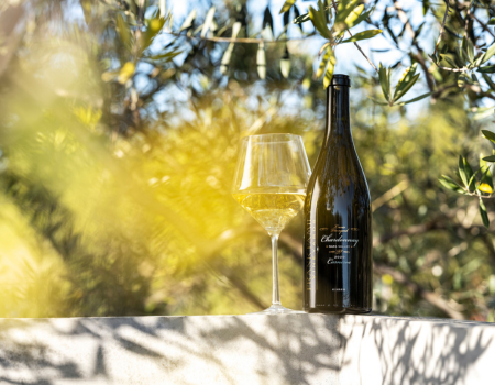 A bottle of Lewis Vineyard Chardonnay in an olive tree