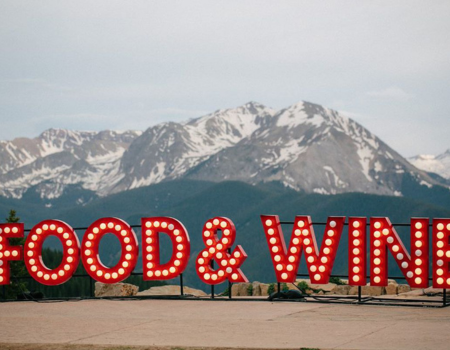 Food & Wine sign with snow-capped mountains behind