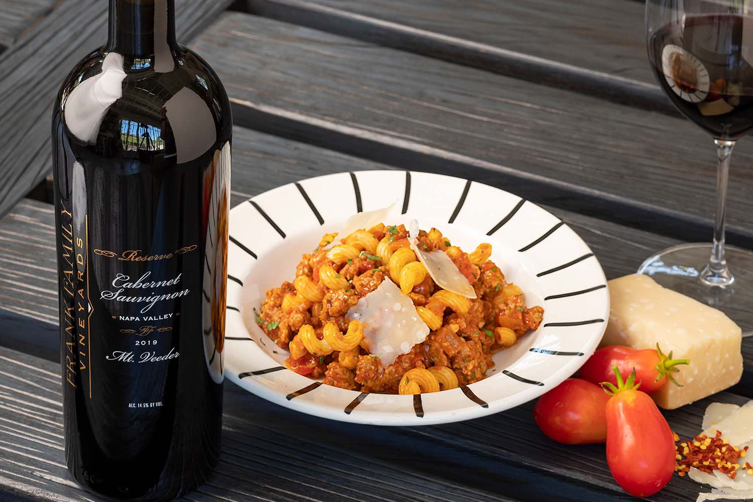 Sausage Cavatappi with a bottle of wine and wine glass