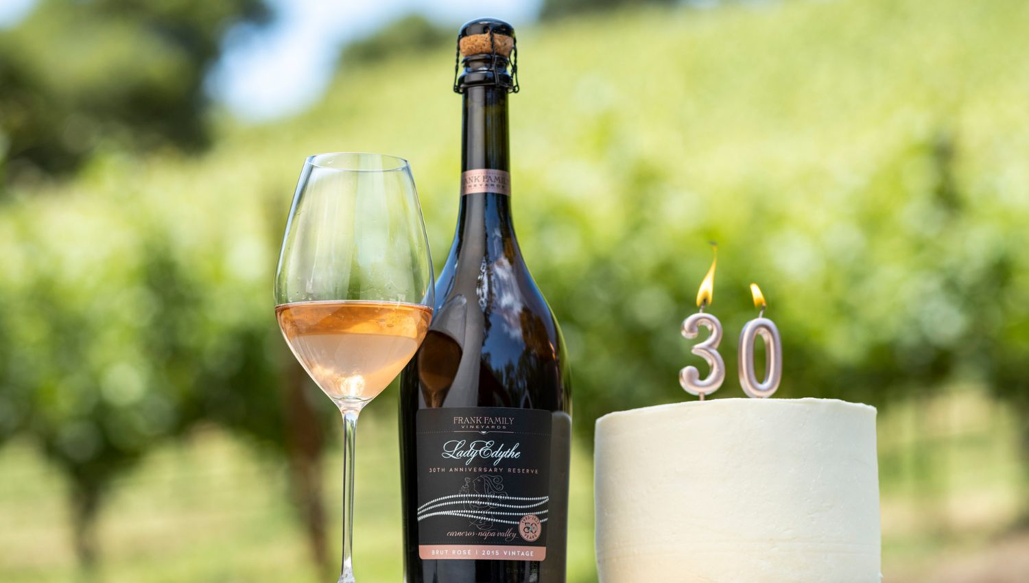 A bottle of the Lady Edythe Reserve Brut next to a cake with a 30th candle