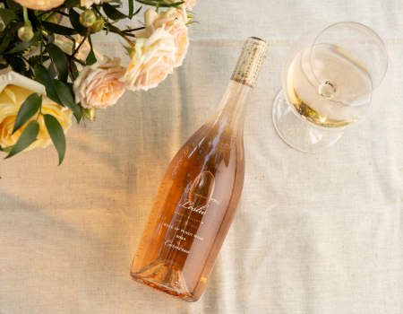 Bottle of 2024 Leslie Rosé next to florals