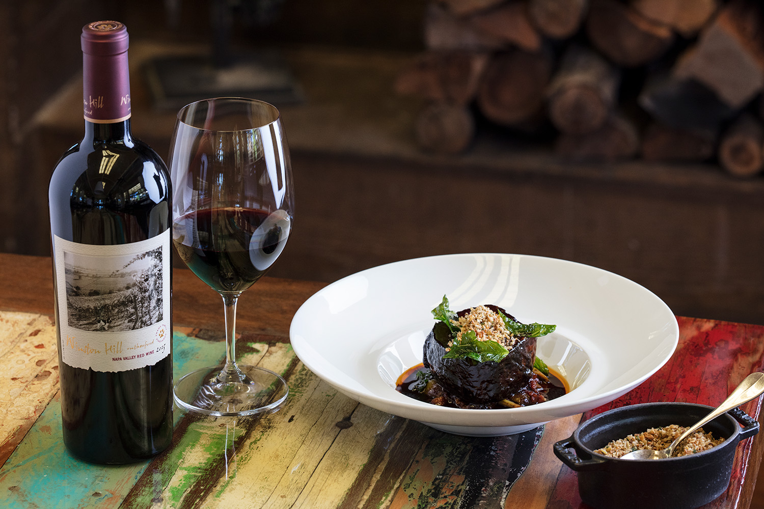 Beef Short Rib with Sofrito-Braised Beans next to a bottle of Frank Family's Winston Hill