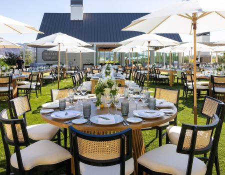 The Miller House Lawn set with tables and chair for a dinnertime event