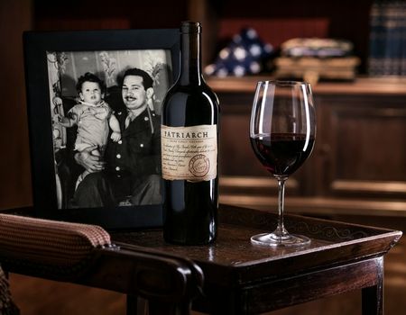 Patriarch bottle and photo of father and son